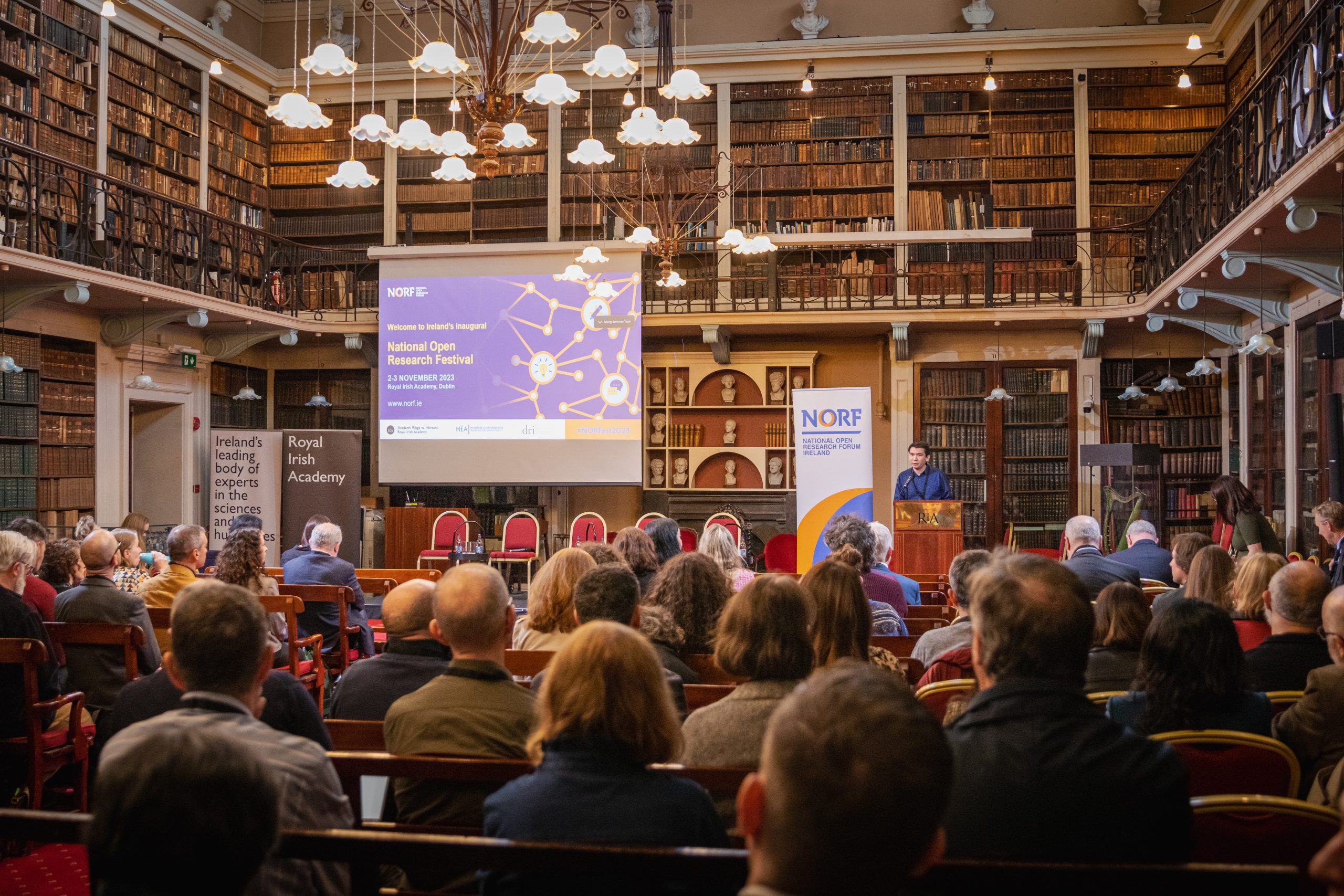 Daniel Bangert National Open Research Coordinator presenting to a crowded room at the Royal Irish Academy at NORFest 2023 in Dublin, Ireland