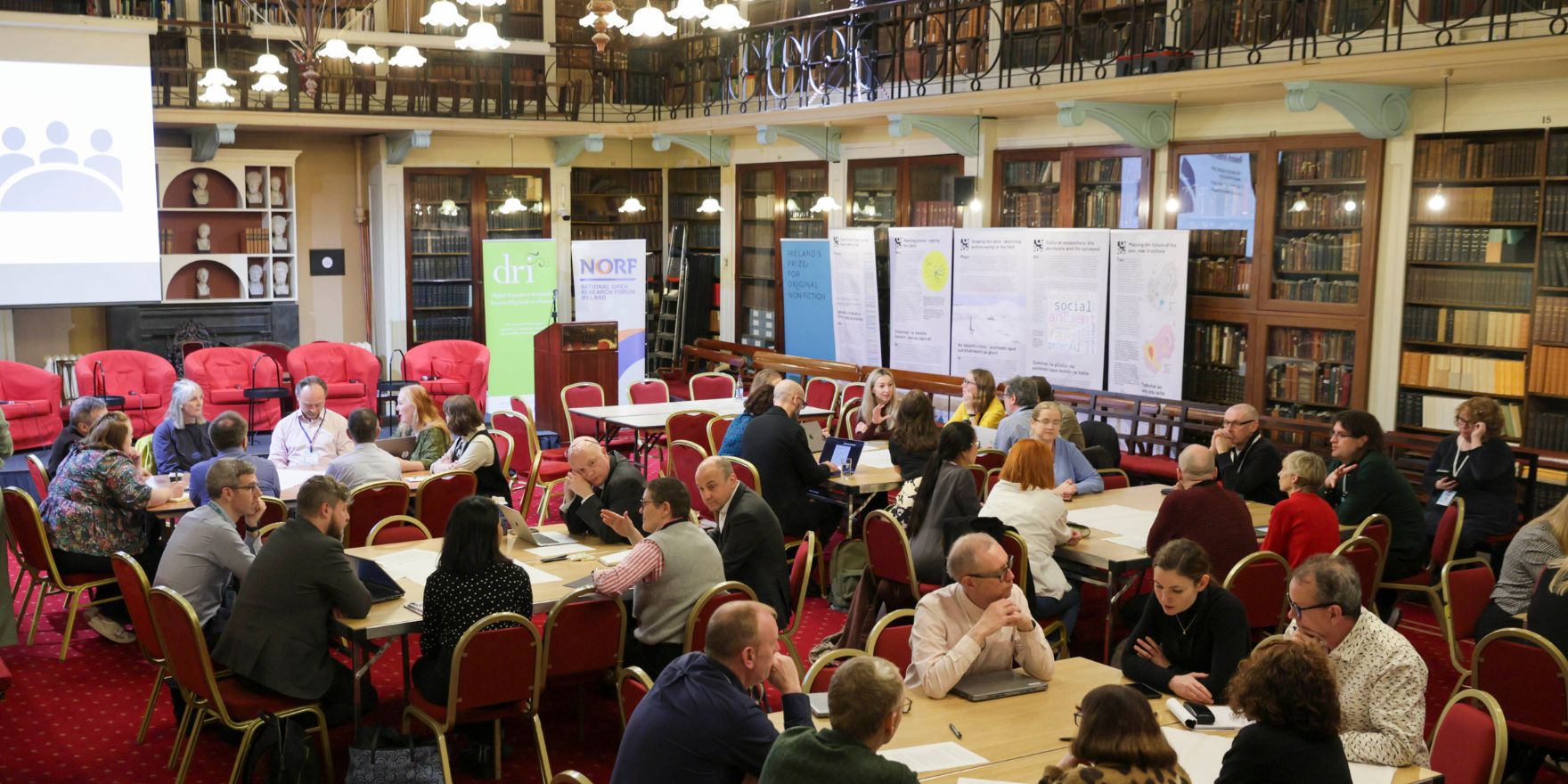 Attendees of the NORF Workshop sitting at tables in the Meeting Room of the Royal Irish Academy, discussing the topics of the day.